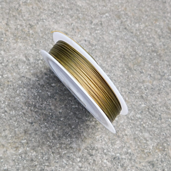 Tigertail, plastad smyckeswire - guldfärgad 0,38 mm
