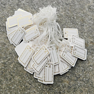 Prislappar med guldtext 100 pack